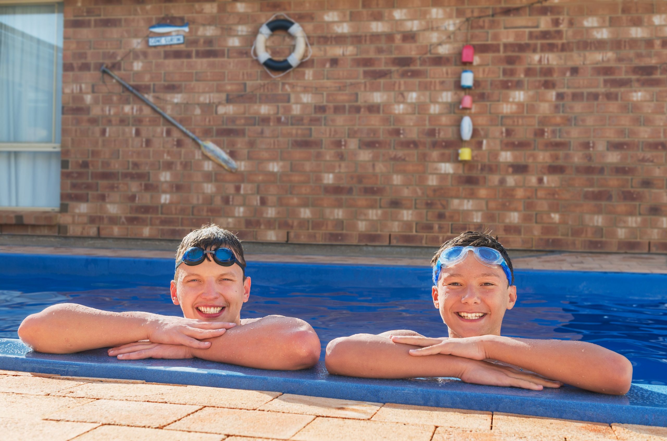 Kids playing in a home inground pool